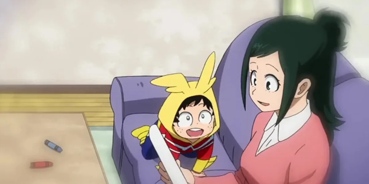 Inko Midoriya on the couch with young Deku in a hero hoodie