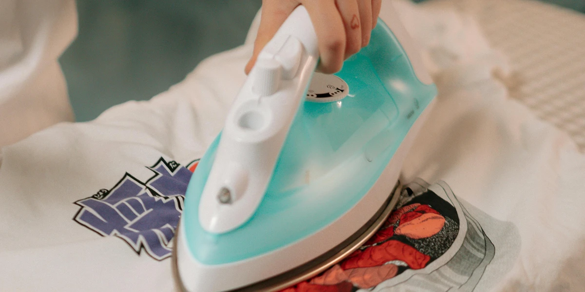 Ironing on the print of white graphic t-shirt
