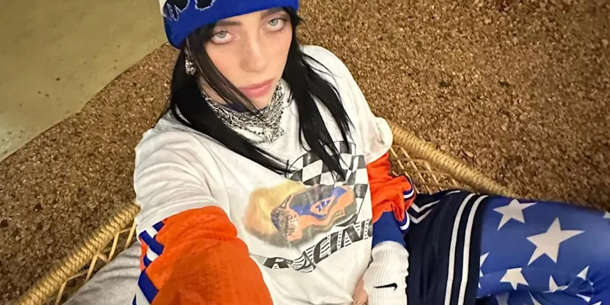 Billie Eilish wearing layered streetwear and athletic-inspired fashion during a recent era
