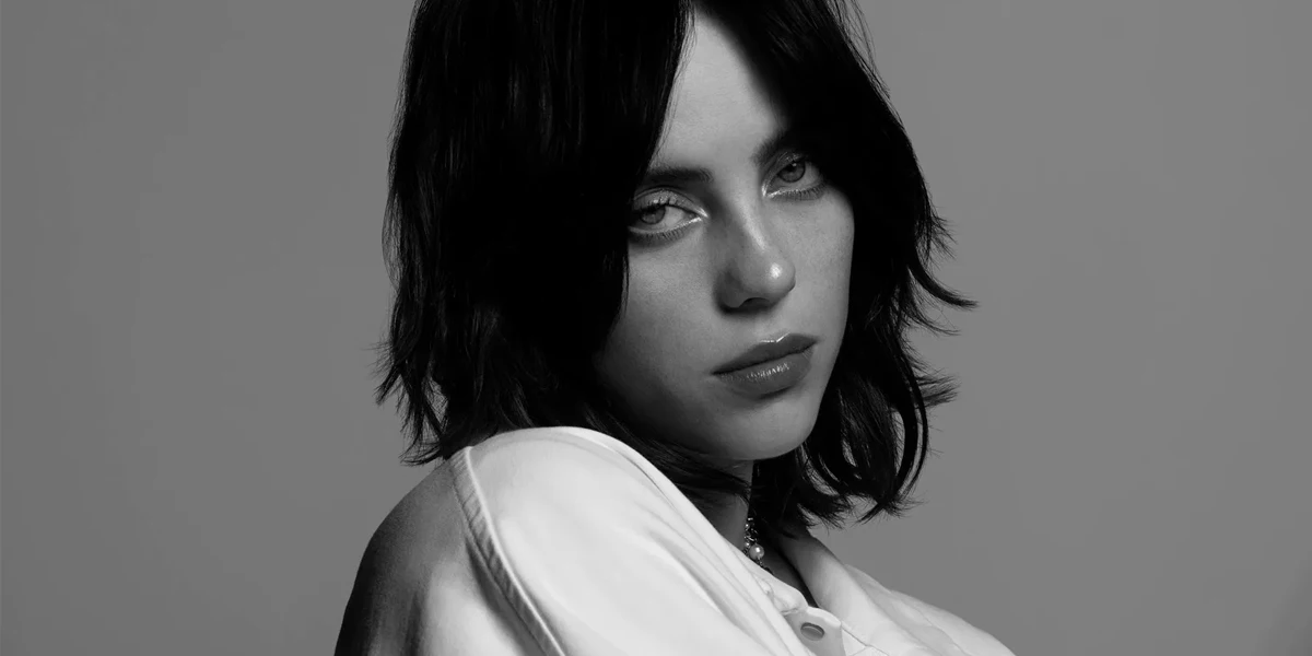 Black and white close-up portrait of Billie Eilish with a quiet and reflective expression