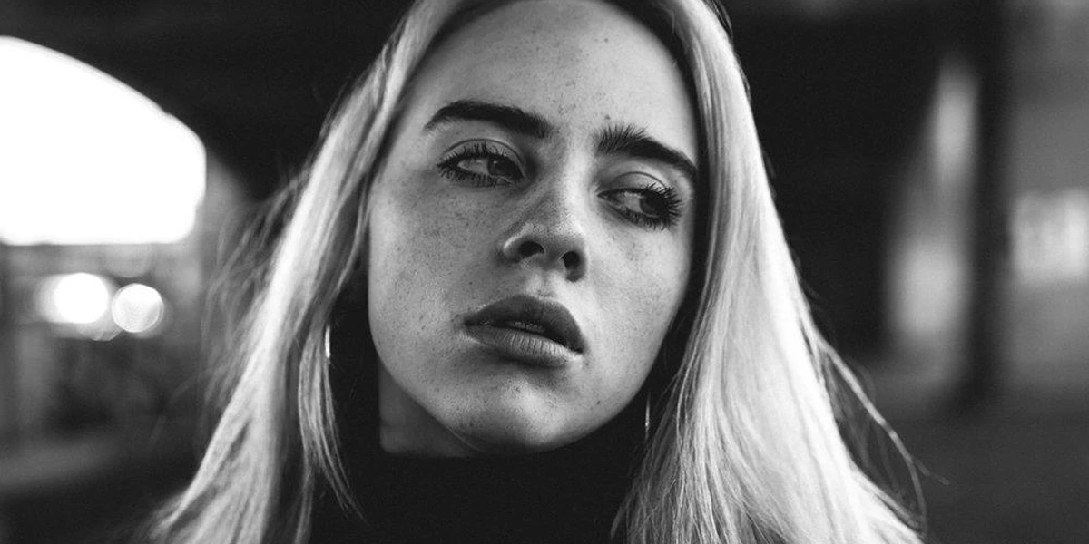 Black and white portrait of Billie Eilish looking emotionally distant and lost in thought