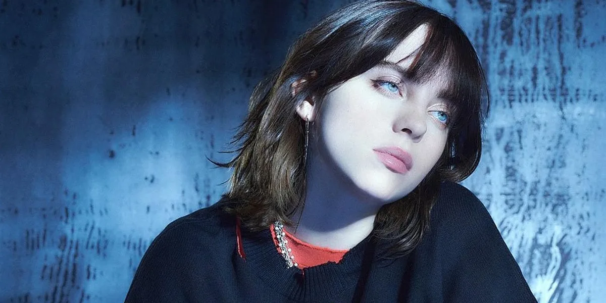 Billie Eilish portrait with a quiet reflective expression in soft blue lighting