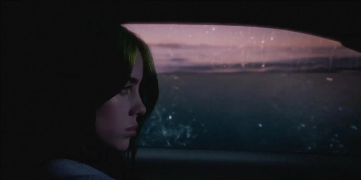 Billie Eilish sitting silently inside the underwater car scene from the everything i wanted music video