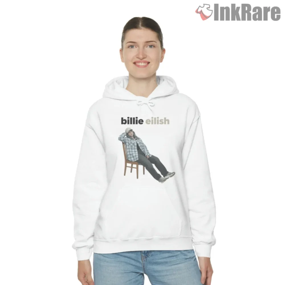 White hoodie with Billie Eilish seated in a chair flannel streetwear portrait and bold name above