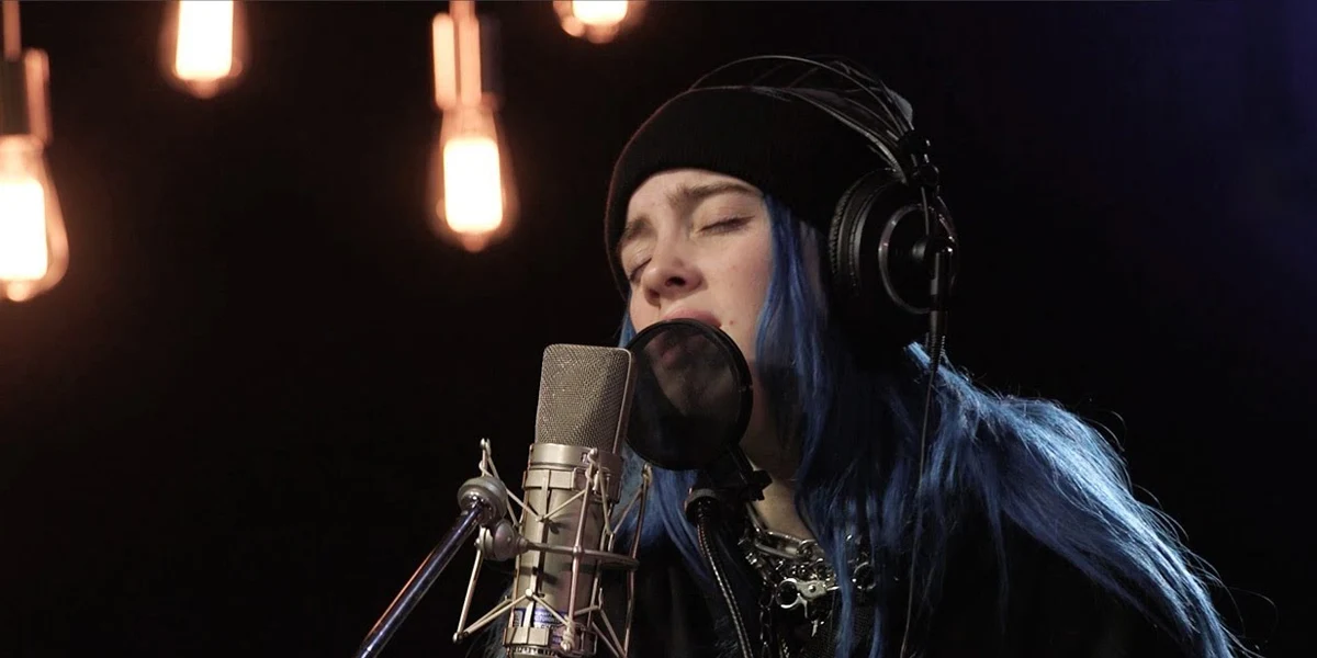 Billie Eilish recording an emotional vocal performance in the studio during the when the party’s over era