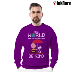 Men’s In A World Where You Can Be Anything Be Kind Snoopy Crewneck Sweatshirt in purple | Cozy Fabric, Clean Style