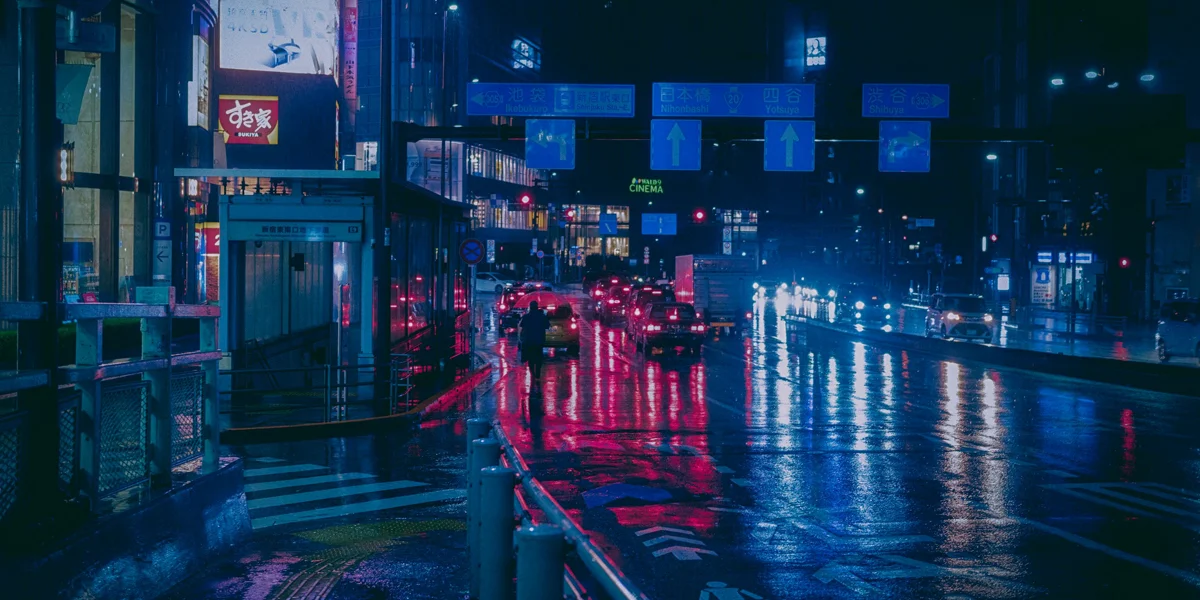 Rainy neon city street at night with a quiet cinematic mood