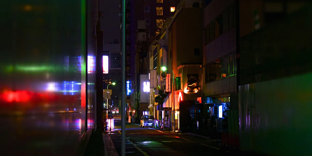 Empty neon lit city street at night reflecting the lonely atmosphere of Lana Del Rey music