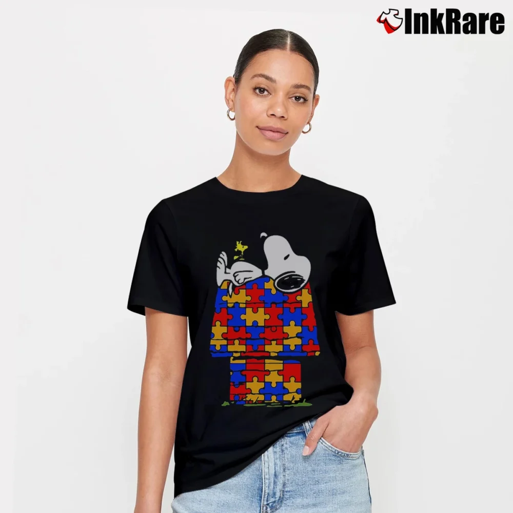 Women’s Snoopy Sleeping On His Dog House Puzzle Pieces Shape T-Shirt in black | Soft, Flattering Fit